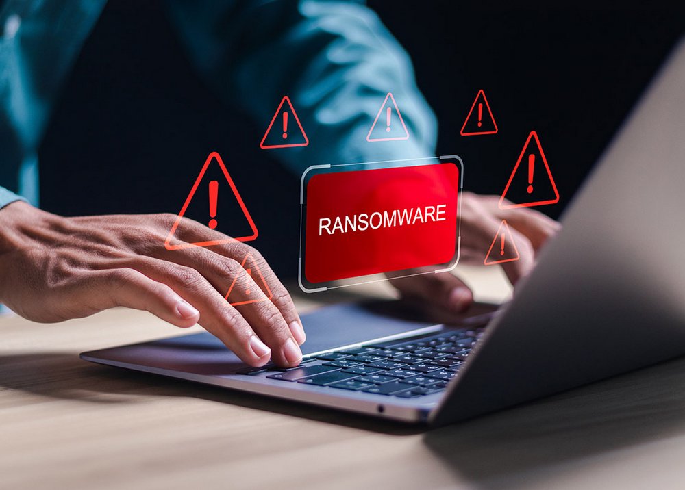 Malware attack virus alert. Person use laptop with virtual warning sign with ransomware word. warning notification, Cyber threats.
